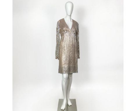 A dazzling vintage long sleeved peach dress covered in iridescent sequins. Bust: 16"W. Waist 13"W. Sleeve length: 25"L. Full 