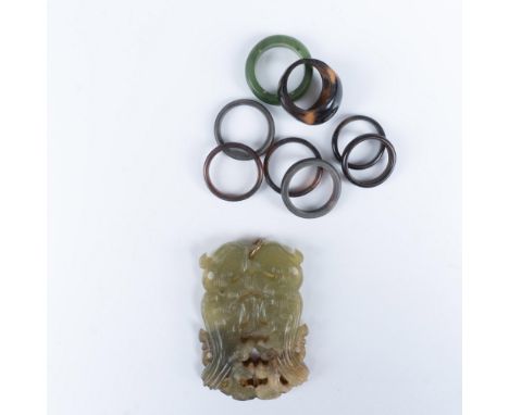 Handsome collection of jewelry that consists of 6 Bakelite rings in the sizes 5, 5.5, 7, 7, 7.5, 7.5; a size 4 wooden ring, a