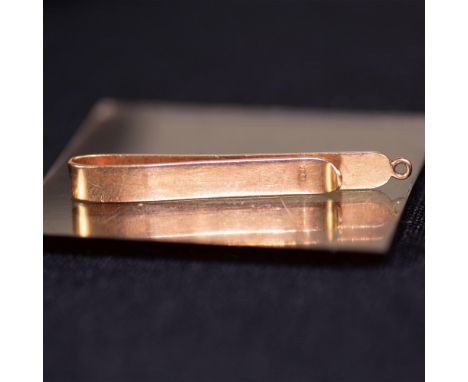 Elegant 18K gold tie clip with a whole to use as a pendant as well. Weight 4.30 grams. Measures approx. 2"L. Marked 18K. Dime