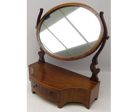 Inlaid mahogany oval swing toilet mirror with curving supports, serpentine base with single cross-banded drawer and bracket f