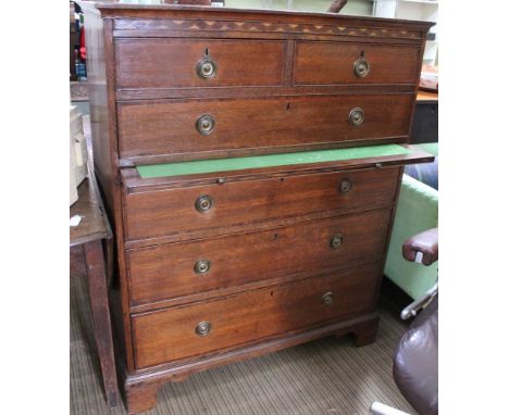 A 19th century oak chest on two short over four long drawers, with brass ring handles, fitted baize lined brushing slide, the