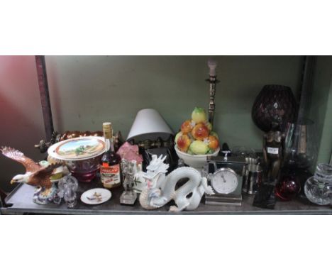 A shelf containing a varied selection of items, to include a 'John Letts' resin nude figure of a lady, etc