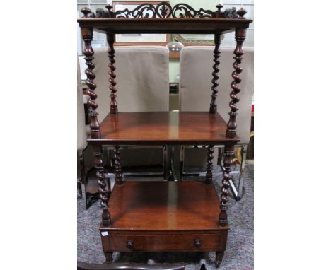 A 19th century mahogany three tier Whatnot, top with 3/4 pierced gallery, raised on barley twist spirals, to the base a drawe