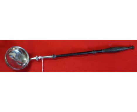 A Scottish George lV silver ladle, with turned ebonised handle, Edinburgh 1824, 39cm