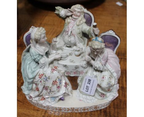 A Continental ceramic figure group, figures in 18th century costume taking tea