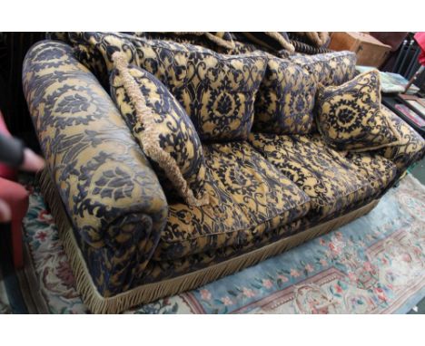 A large sitting room sofa with scroll arms in a dark blue & gold cut fabric, deeply fringed Condition: a little wear / fading