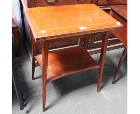 An Edwardian mahogany fold over card table with undertier