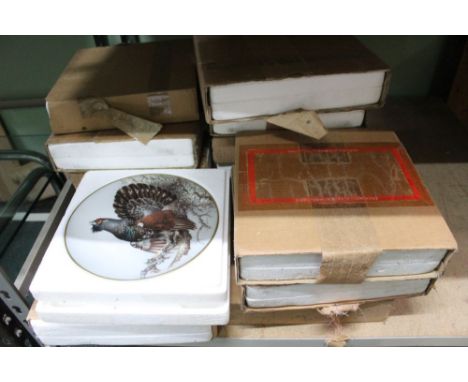 A shelf of brand new collectors plates, various