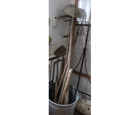 A metal bin containing a selection of vintage tools