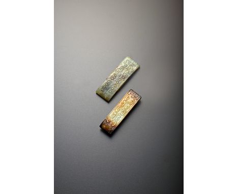 TWO CHINESE CELADON JADE SCABBARD SLIDES HAN DYNASTY 206BC - 220AD Each of rectangular form, carved in shallow relief with tw