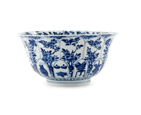 A CHINESE BLUE AND WHITE MOULDED BOWL KANGXI 1662-1722 The flared body with a scalloped rim, painted with petal-shaped panels