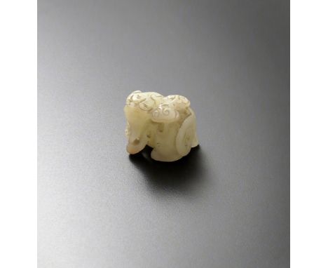 A CHINESE PALE CELADON JADE CARVING OF A BUDDHIST LION DOG 19TH CENTURY In a crouching position, his head raised with a lingz