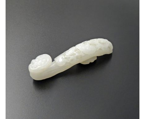 A CHINESE WHITE JADE BELTHOOK 18TH/19TH CENTURY Naturalistically carved with lingzhi fungus, 8.1cm.  十八/十九世紀    白玉雕如意靈芝帶鉤
