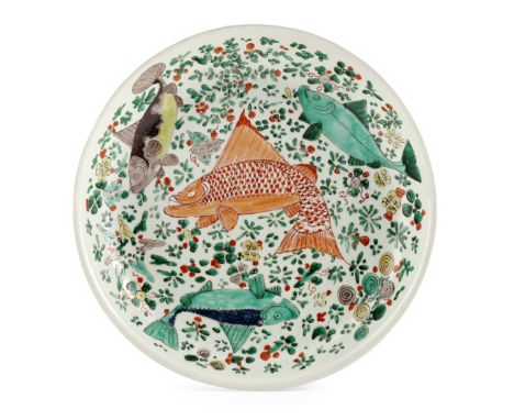 A CHINESE FAMILLE VERTE DISH KANGXI 1662-1722 Painted with four fish, swimming amongst reeds, the base with a shop mark, 35.2