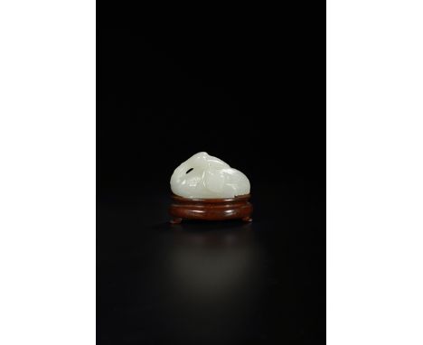 A CHINESE PALE CELADON JADE CARVING OF A CRANE QING DYNASTY Seated with its legs tucked neatly beneath its body, its head tur