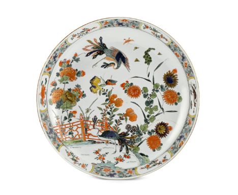 A LARGE CHINESE FAMILLE VERTE DISH KANGXI 1662-1722 Painted with a peacock in a fenced garden, another in flight above, with 