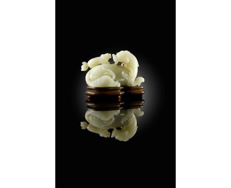 A CHINESE PALE CELADON JADE MODEL OF A KYLIN QIANLONG 1736-95 Crisply carved in a recumbent position, its head turning back o