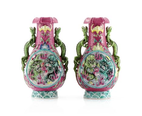 A PAIR OF CHINESE FAMILLE ROSE DRAGON VASES 20TH CENTURY Moulded in high relief with panels of dragons with articulated eyes,