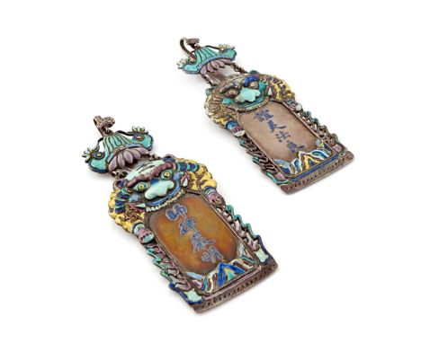 A PAIR OF CHINESE SILVER AND ENAMEL PLAQUES LATE QING Each with columns of calligraphy above rockwork, surmounted by a mythic