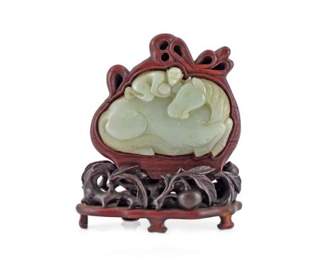 A CHINESE PALE CELADON JADE PLAQUE 18TH/19TH CENTURY Carved as a recumbent horse, with a monkey holding two peaches and clamb