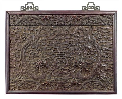 A CHINESE HARDWOOD RECTANGULAR PANEL QING DYNASTY Carved in relief with five-clawed dragons amongst clouds encircling a centr
