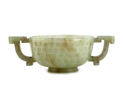 A SMALL CHINESE CELADON JADE TWO-HANDLED CUP 18TH/19TH CENTURY Of compressed circular form, the body raised on a short circul