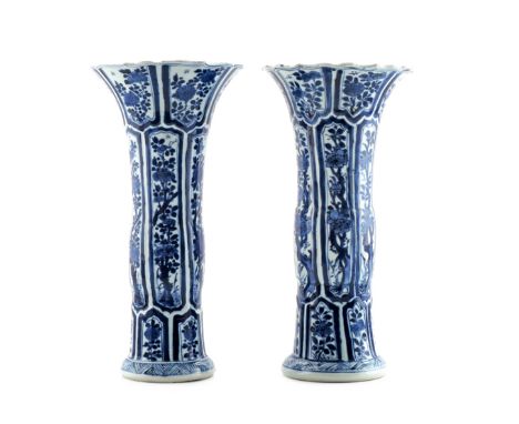 A PAIR OF CHINESE BLUE AND WHITE GU BEAKER VASES KANGXI 1662-1722 Each painted with panels of flowering branches, the scallop