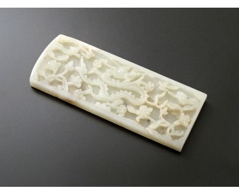 A CHINESE RECTANGULAR PALE CELADON JADE PLAQUE LATE MING DYNASTY Carved in shallow relief with a single confronting scaly dra