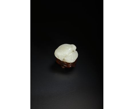 A CHINESE PALE CELADON JADE CARVING OF LOTUS QING DYNASTY With two large seed pods resting on a single lotus leaf, with tendr