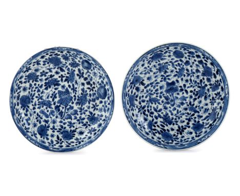 A PAIR OF CHINESE BLUE AND WHITE DISHES KANGXI 1662-1722 Decorated with flowers and foliage, each with an artemesia leaf mark