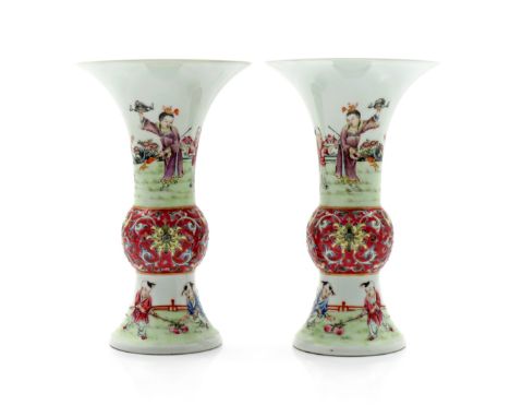 A PAIR OF CHINESE FAMILLE ROSE GU-SHAPED VASES 20TH CENTURY Painted with boys at play in fenced rocky gardens, the central bu
