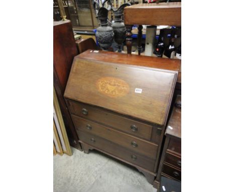 A georgian style mahogany bureau raised on bracket feet