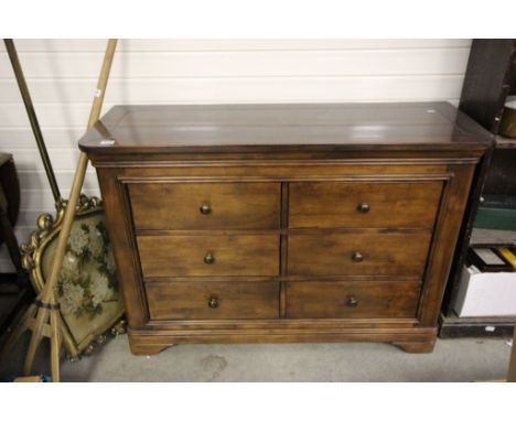 A contemporary mahogany six drawer cabinet raised on bracket feet.