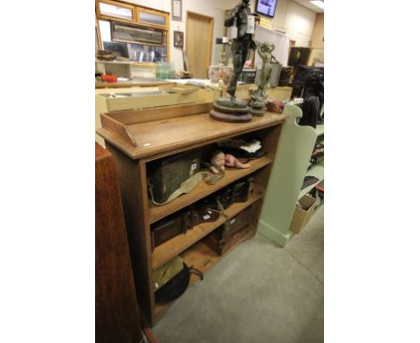 A early 20th century oak bookcase with shaped frieze raised on bracket feet.