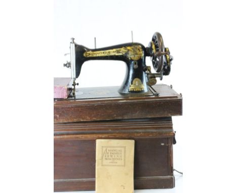 Two vintage wooden cased Singer sewing machines