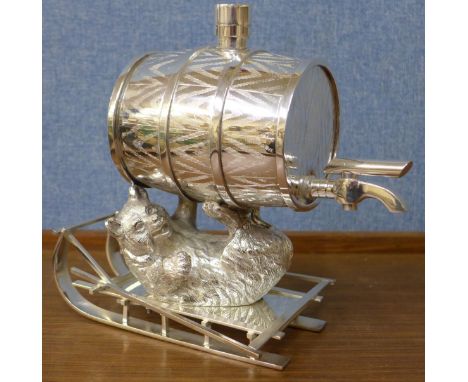 A Russian style white metal spirit flask, in the form of a bear on a sledge holding aloft a barrel