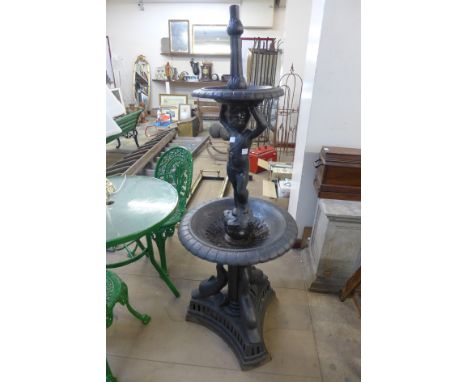 A cast iron figural cherub water fountain