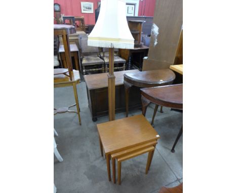 An Art Deco oak standard lamp and a teak nest of tables