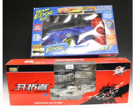 A Team Edge R/C hovercraft, boxed; a remote control helicopter, boxed