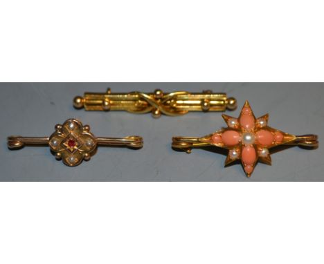 A Victorian ruby and seed pearl bar brooch (unmarked); another, set with seed pearls and coral; a 15ct gold bar brooch (3)