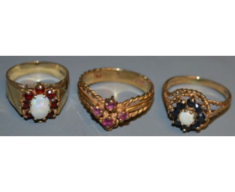 A 9ct gold ring, set with opal and sapphires; another, similar, opal and garnet; etc (3) 9.09g total