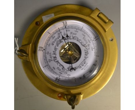 A reproduction wall hanging ships barometer, tinted dial and register, brass case