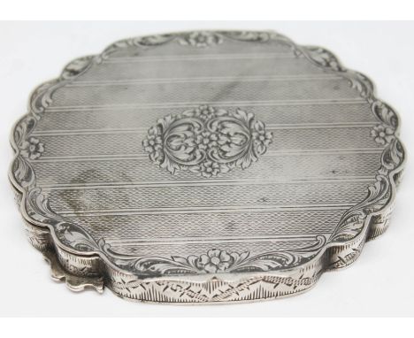 A 19th century continental silver compact with shaped edge, engraved floral border and central floral design, 9.5cm x 8cm, ma
