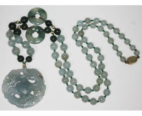 A carved jade necklace, length 76cm.  