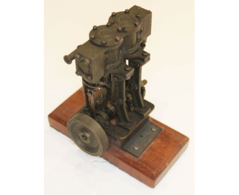 A twin cylinder stationary model steam engine on wooden base, height 16cm.  