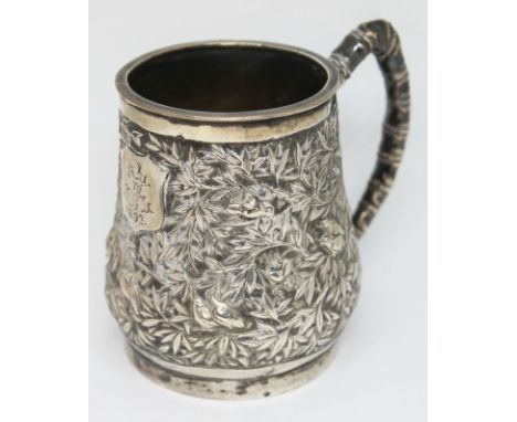 A Chinese export silver tankard by Sun Shing, double walled body decorated profusely with birds amongst trees and with natura