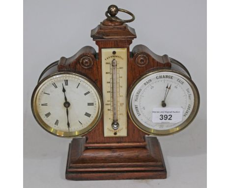 A Victorian oak combination clock, thermometer & barometer, height 22cm.Condition: chip to the oak at the top, pierced holes 