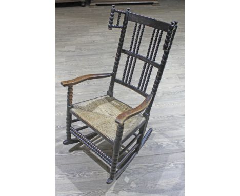 A Victorian bobbin turned rush seated rocking chair.  