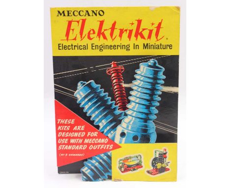 Meccano Elektrikit card pop out sign, comprising a large yellow banner with red info triangle with a tesla on the background,