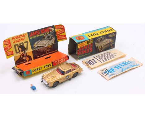 Corgi Toys No. 261 James Bond's Aston Martin DB5, metallic gold body, with wire wheels and both figures, stickers have been a